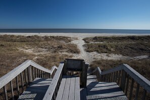 A wooden staircase leading to a beach with a clear view of the ocean. - Stunning Oceanfront 2BR Villa with Panoramic Atlantic Views (Hilton Head Island)