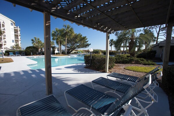 A pool area with lounge chairs and a pergola. - Stunning Oceanfront 2BR Villa with Panoramic Atlantic Views (Hilton Head Island)