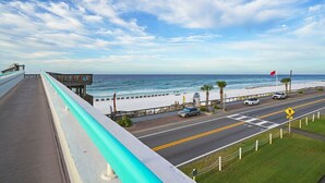 A coastal road with a beach view, a pedestrian crossing, and a sign for Surfside. - Surfside G19 - Condo in Surfside Resort with Many Shared Amenities (Miramar Beach)