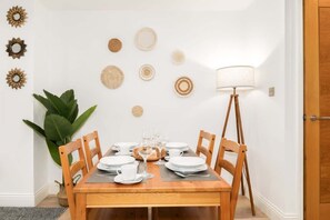 A dining table set with plates, glasses, and a lamp. - Angel 2 BR, 2 Bath Duplex with Balcony Sleeps 5 (Greater London)