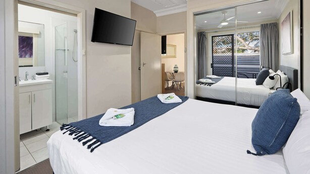 A hotel room with a bed, a TV, a bathroom with a shower, and a balcony with a view. - Prickly Pear Stays in Mayfield (Mayfield)