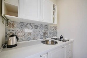 Fridge, stovetop, high chair, cookware/dishes/utensils