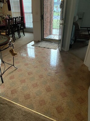 A tiled floor with a doormat, a dining table with chairs, and a small dog toy hanging from the table's leg. - 4-bedroom house in marvelous Hephzibah with AC (Hephzibah)