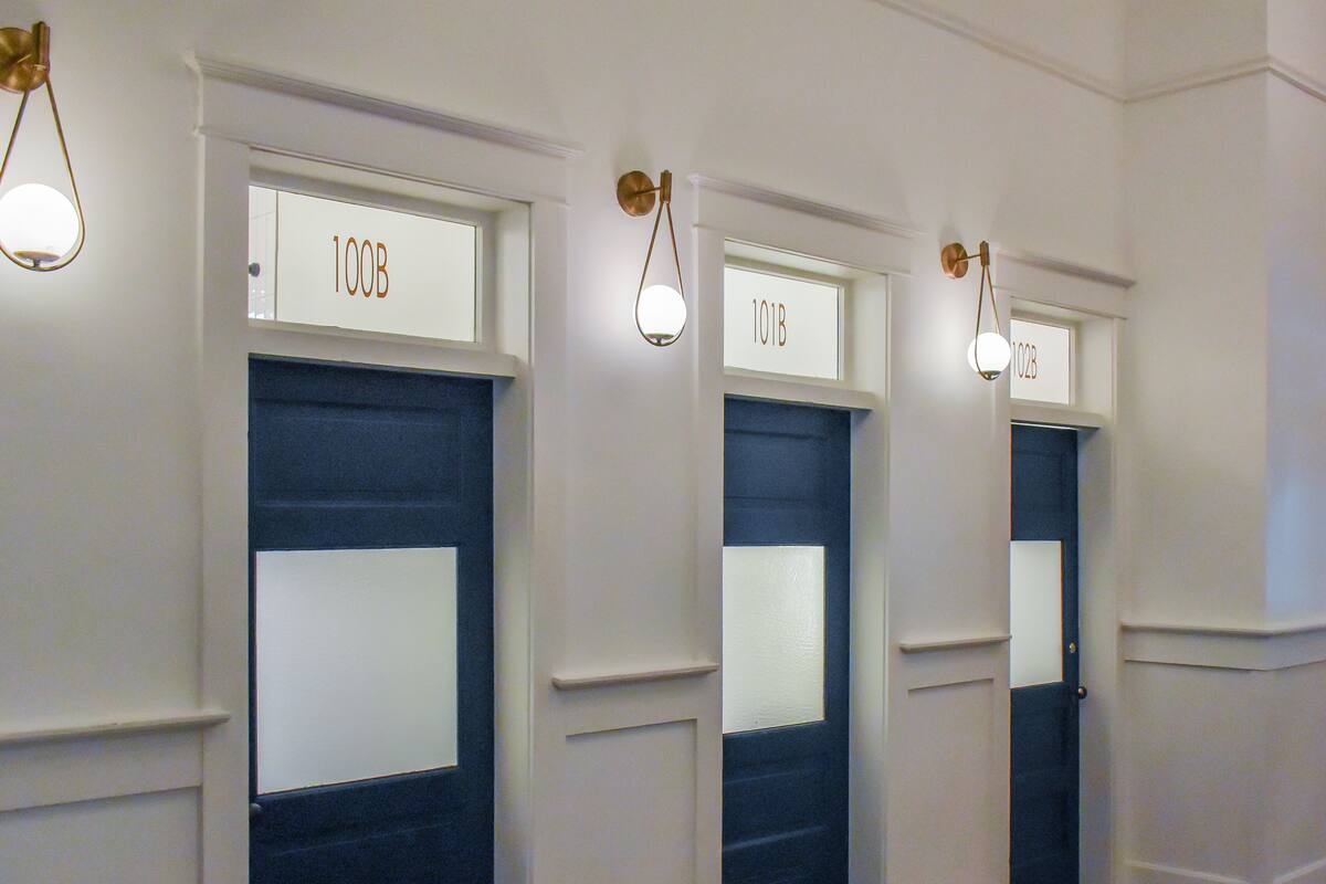 A hallway with doors labeled 100B, 101B, and 102B.