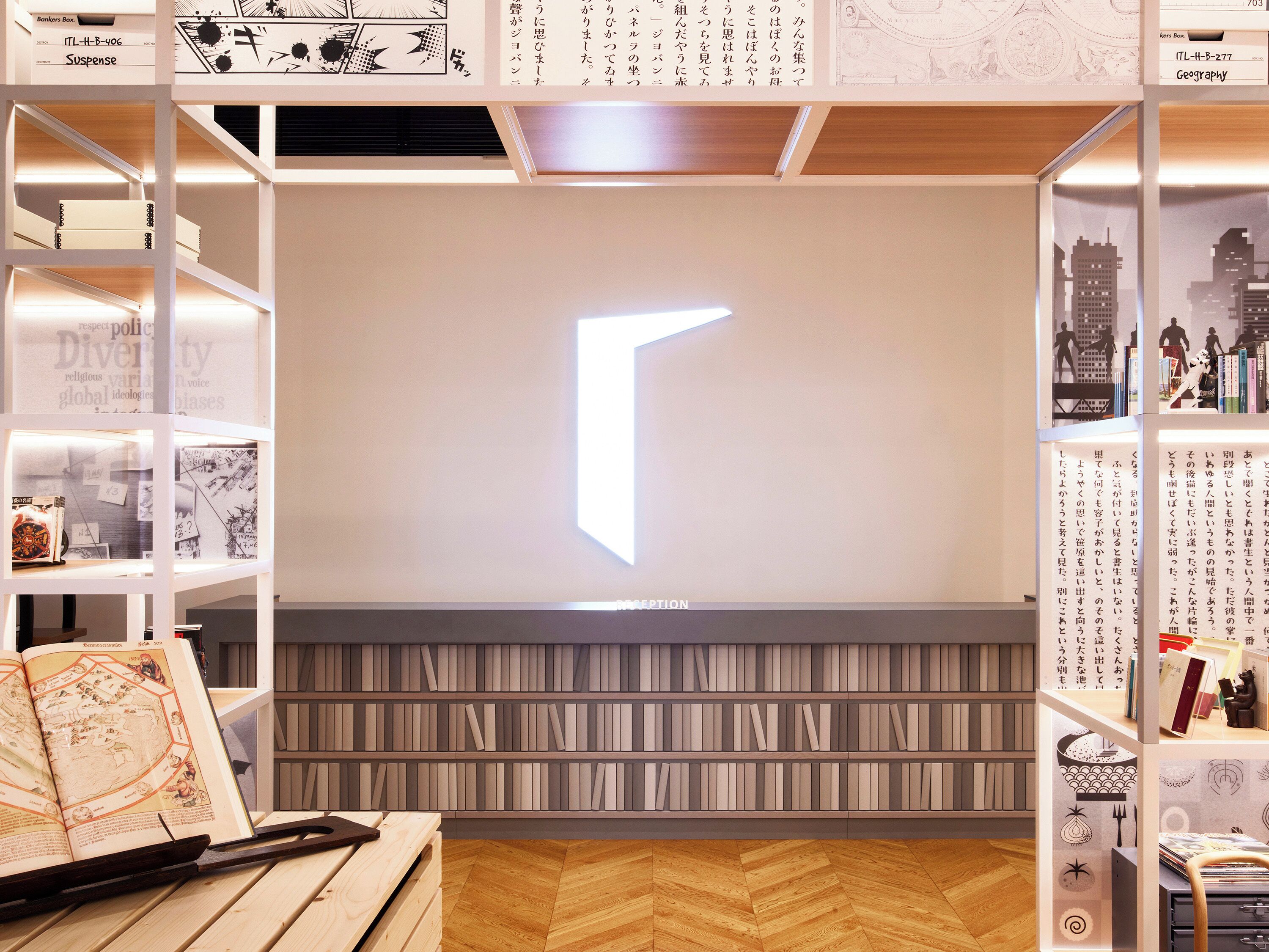 A library with bookshelves, a large illuminated arrow, and a herringbone-patterned floor.
