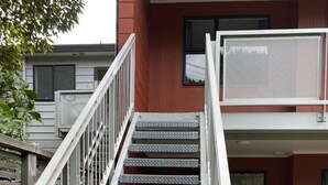 A metal staircase with a handrail leading to a second-floor balcony. - Robins Retreat-Town Center - Parking - Easy access (Queenstown)