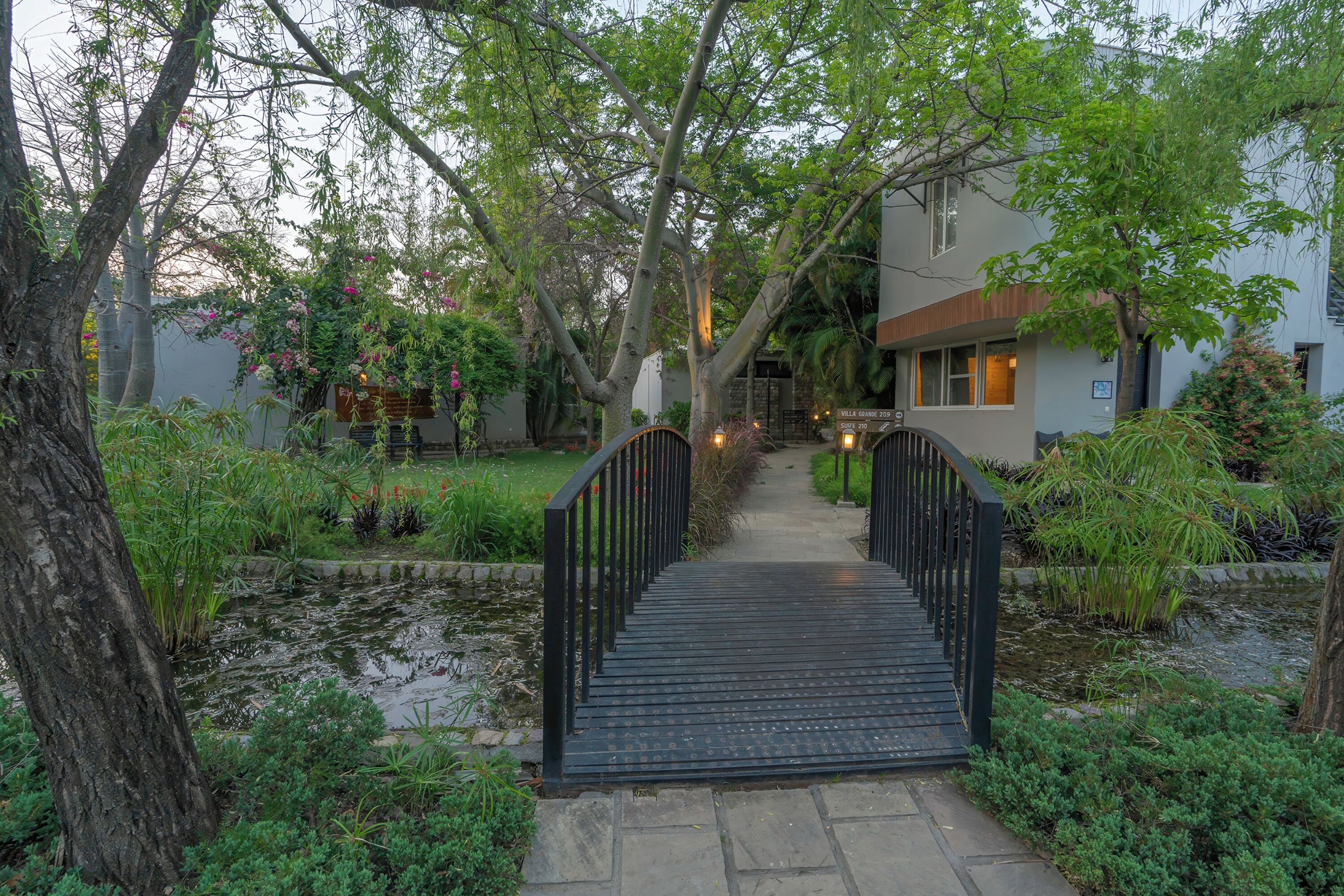 A wooden bridge leading to a building with a sign reading 'Villa Villa 2019.'