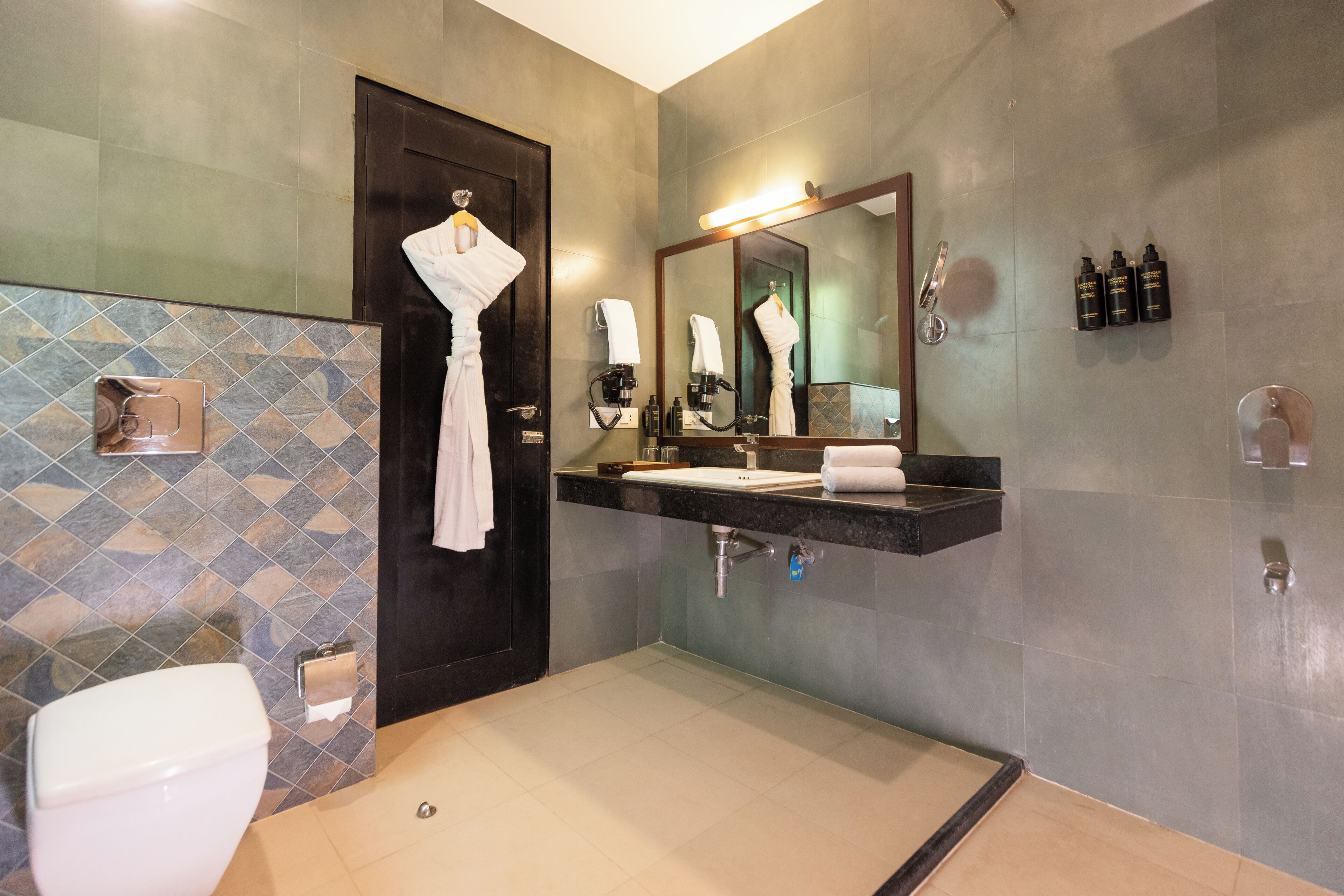 A modern bathroom with a shower, toilet, and sink.