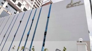 A modern hotel building with a prominent sign reading "Lara Resort Hotel". - The Aura Residence (Sihanoukville)