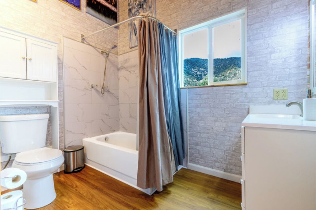 A bathroom with a bathtub, toilet, and sink.