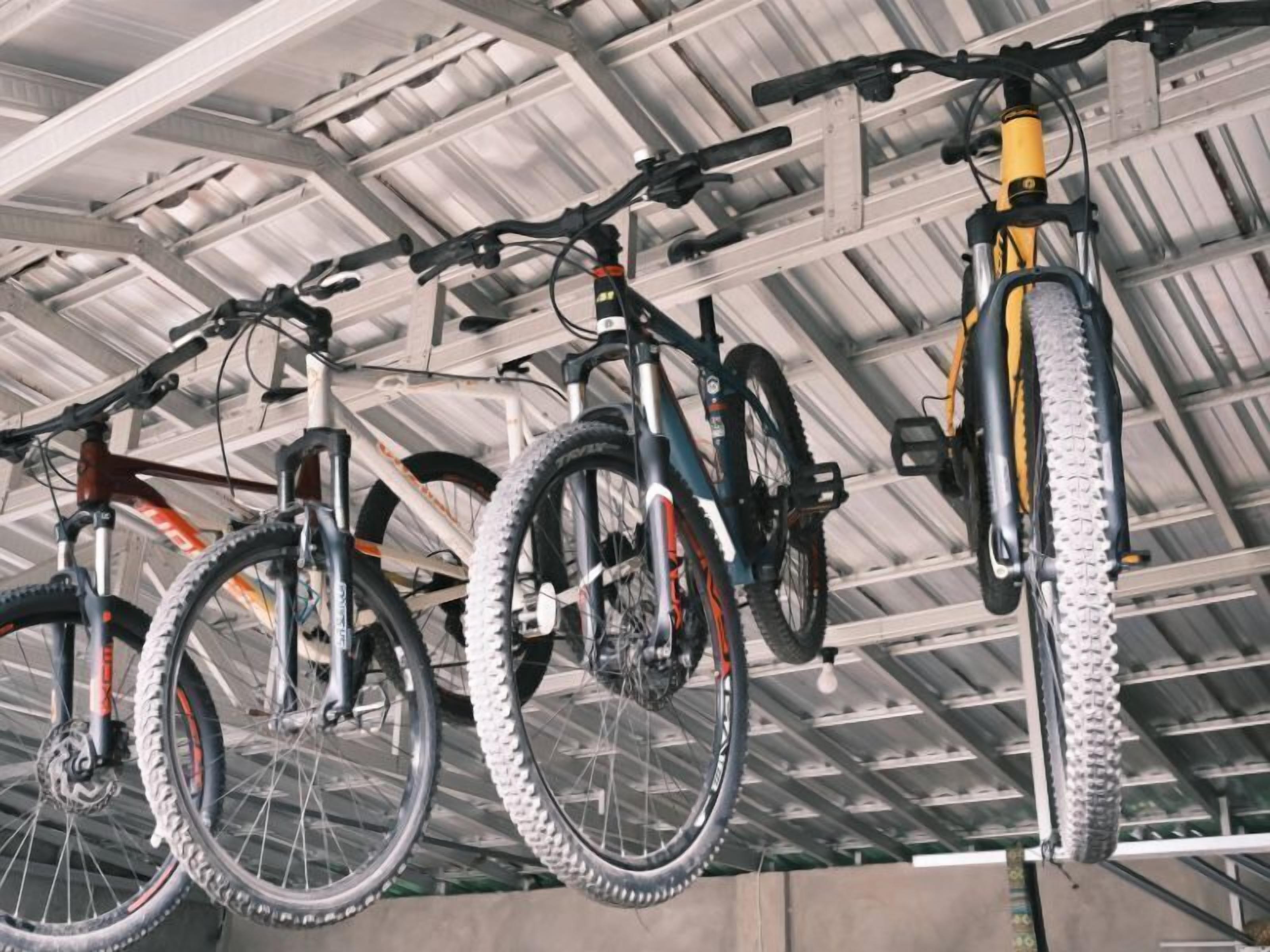 A covered bike parking area with multiple bicycles.