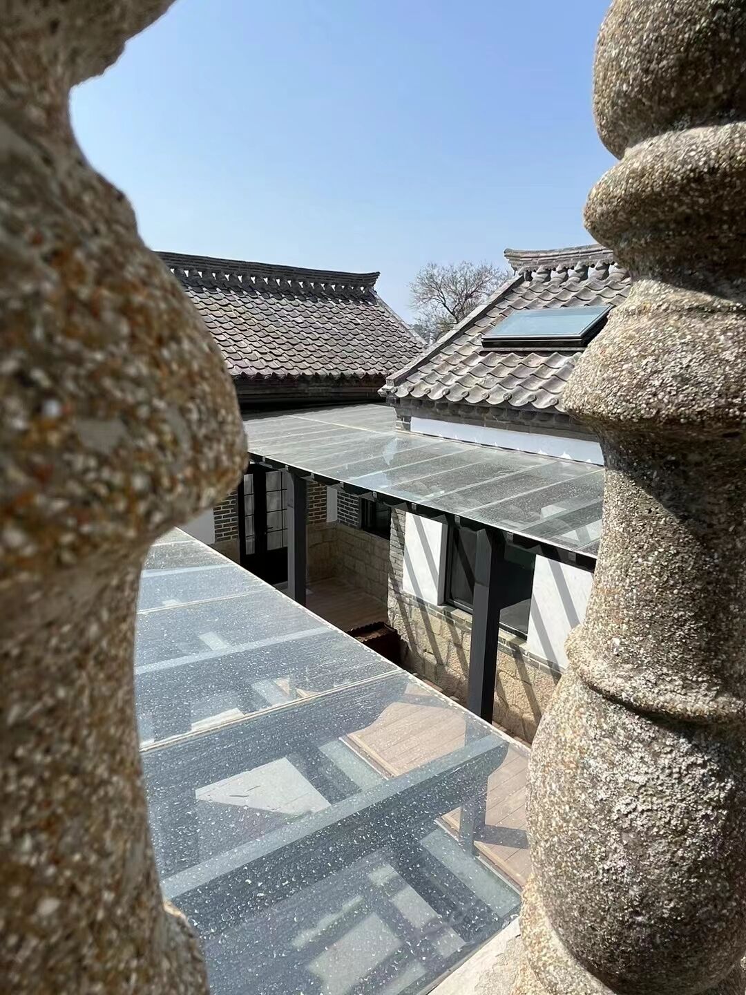 A traditional Korean building with tiled roofs and a stone balustrade.