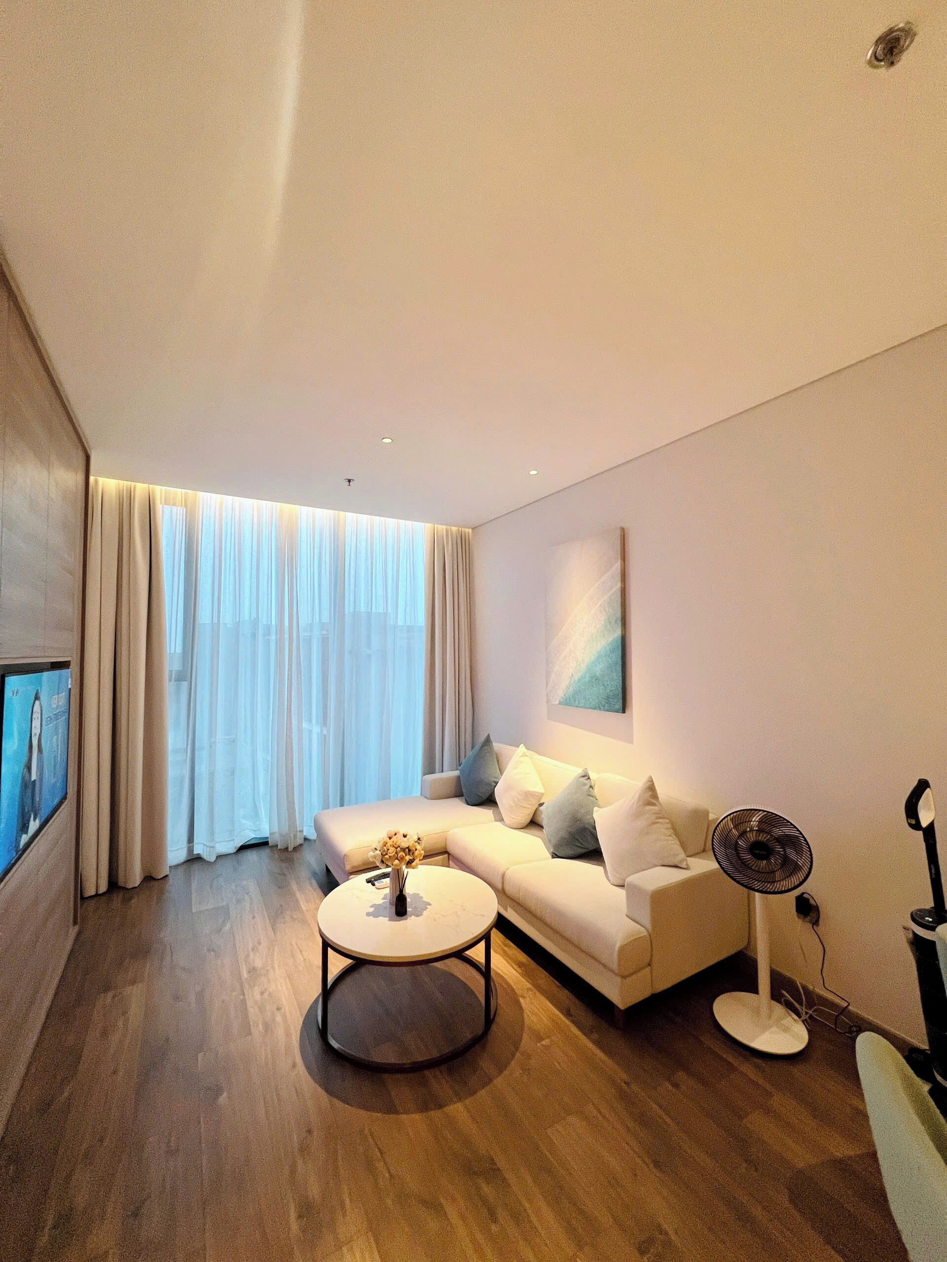 Una sala de estar moderna con un sofá, una mesa de centro y un televisor.