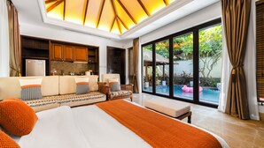 A spacious bedroom with a large bed, a seating area, and a view of a swimming pool. - GuangPo MeiYa Homestay LingShui (Lingshui)