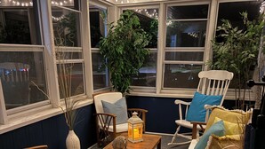 A cozy corner with a wooden table, chairs, and a lantern. - Charming Wisconsin Dells, Devil’s Lake, & Circus World Retreat! (Baraboo)