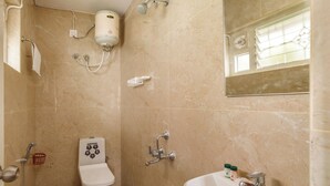 A bathroom with a toilet, sink, and shower. - The City Nova Apartment Koramangla (Bengaluru)