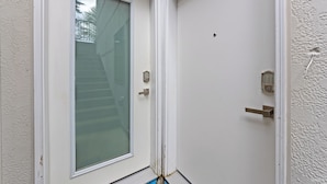 A white door with a glass panel and a metal handle.