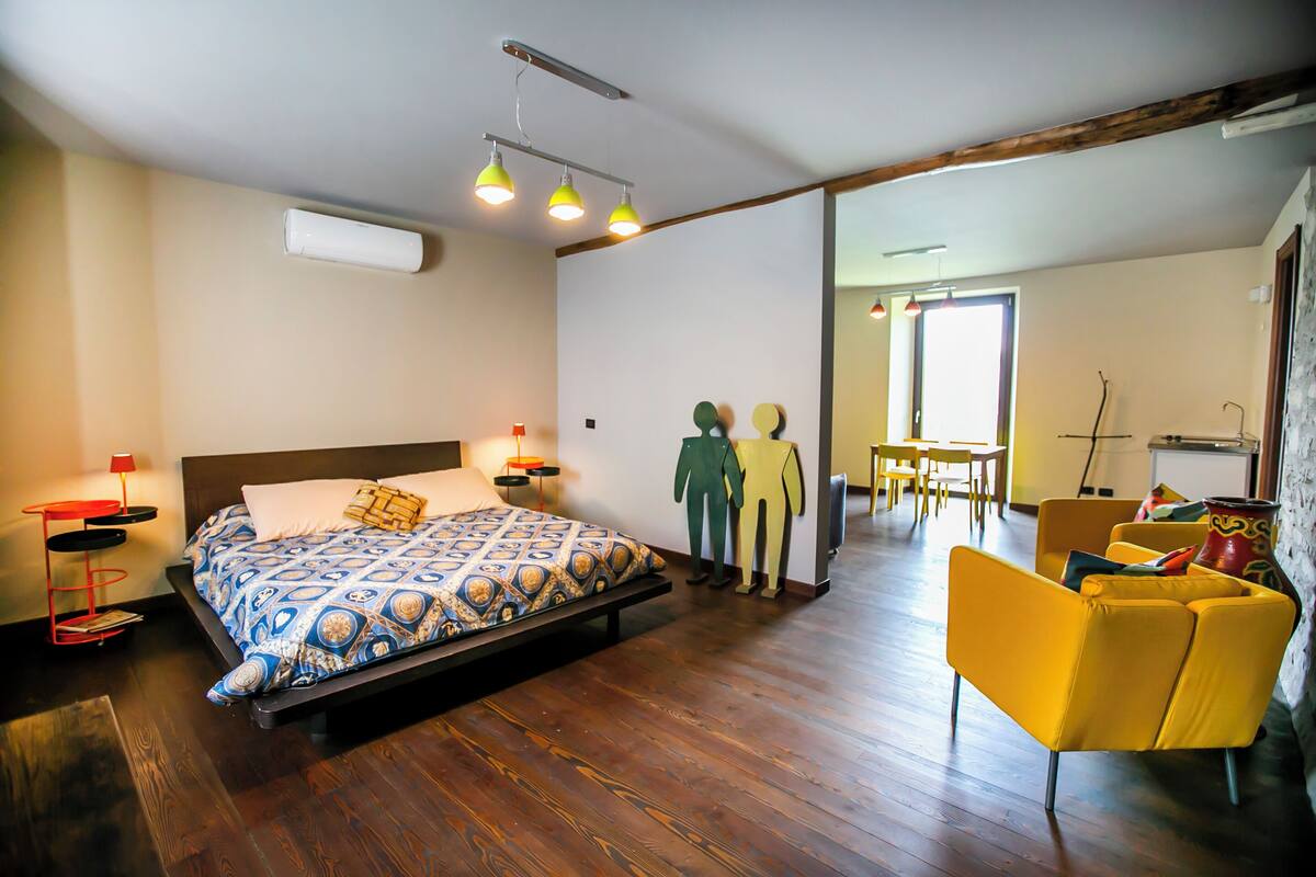 Una camera da letto con un letto, comodini, una sedia e una scrivania.