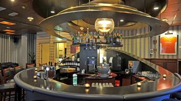 Enjoy a drink at the bar, where a coffee machine and selection of beverages are available.