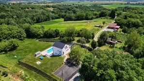 An aerial view of a rural property with a large white building, a swimming pool, and surrounding green fields. - Villa M.I.L.A. by Villas Guide (Bjelovar)