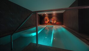 Relax by the pool, surrounded by a serene atmosphere and elegant lanterns.