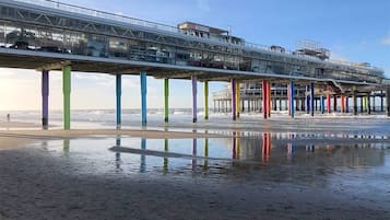 Stroll along the pier's glass walkway, supported by colorful pillars.