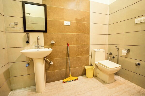 A bathroom with a sink, toilet, and mirror. - goSTOPS Amritsar Chatiwind Gate (Amritsar)