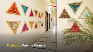 A hallway with triangular wall art and a staircase. - goSTOPS Amritsar Chatiwind Gate  (Amritsar)