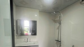 Een badkamer met toilet, wastafel en douche.