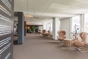 Modern office space with comfortable chairs and potted plants, ideal for focused work and learning.