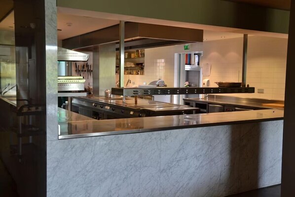 Effortlessly cook and entertain in this well-equipped kitchen with multiple sinks and modern appliances.