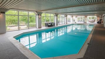 Relax by the expansive pool with a stunning view of the surrounding landscape.