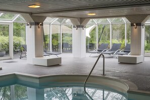 Relax by the pool surrounded by lounge chairs and sunbeds.