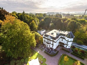 Stunning building with a traditional facade, surrounded by lush gardens and offering expansive views of the surrounding landscape.