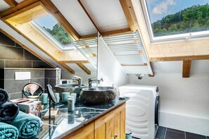 A modern kitchen with a skylight, granite countertops, and a built-in washing machine. - Apartment 'Enjoy Mal' with Shared Garden, Balcony and Wi-Fi (Stockach)