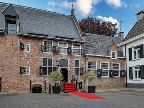 Step into a charming historic property with a traditional brick façade and inviting entrance.