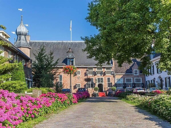 Stroll through the charming streets to this historic building, surrounded by lush gardens and vibrant flowers.