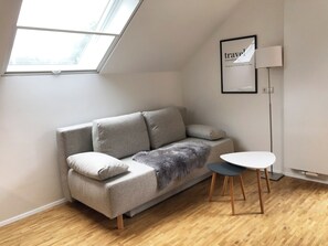 Living area - 1-room attic apartment with lake view and large balcony on the Mettnau (Radolfzell am Bodensee)