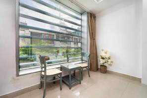 Enjoy a peaceful retreat with a view of the surrounding greenery from this balcony.