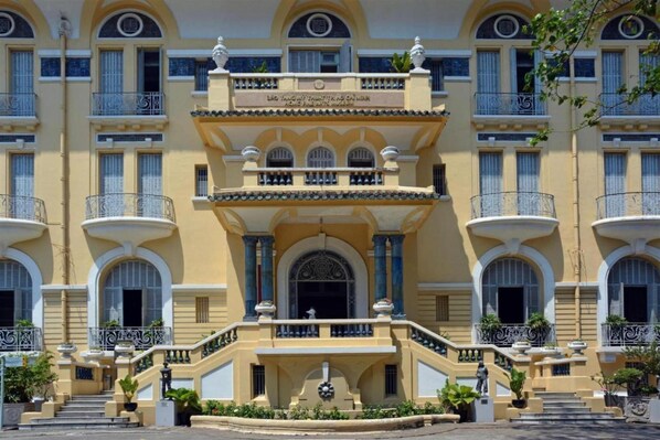 Stunning building with a grand entrance, arched windows, and ornate balconies.