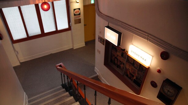A staircase with a wooden handrail, a wall-mounted clock, and a sign that reads "ON AIR". - Pyungtaek1981 (Pyeongtaek)