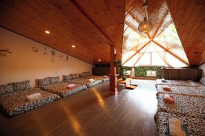 A spacious room with a high wooden ceiling and a sloped roof design. - Homestay 3M House (Cam Ly - Da Lat)
