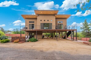 A modern two-story house with a covered patio and a staircase leading to the upper level. - NEW|Oak Creek Retreat|Townhouse w/Views|FirePit (Sedona)