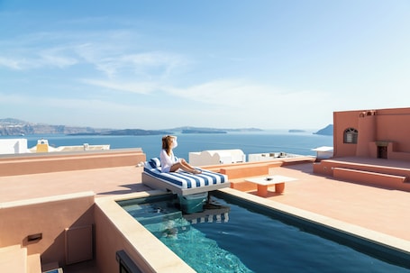 A heated pool. First Floor | Panoramic 2-Bedroom Caldera Residence with Rooftop Oasis - Adults Only, Villa Oro