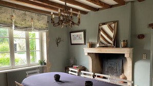 A room with a bed, a fireplace, a window with curtains, and a chandelier. - 19th century manor house "la belle vie" 14/15 persons 5 min from Beaune (Tailly)