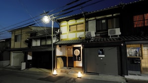 A traditional Japanese building with a two-story structure, a covered entrance, and a sign indicating private resistance.
