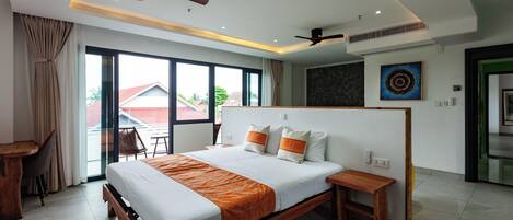 A modern hotel room with a large bed, wooden headboard, and a desk.