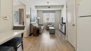 A compact living space with a kitchenette, a dining area, and a seating area with a sofa and armchairs. - Simplicity  1103 I Spacious 1Bd/1bth Apartment (San Antonio)