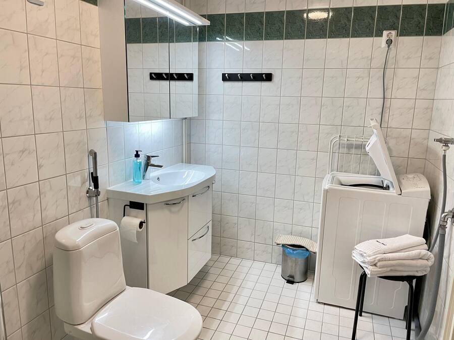 A modern bathroom with a toilet, sink, and shower.