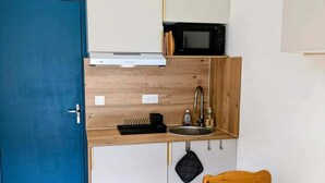A compact kitchenette with a microwave, toaster, and sink. - Cozy studio for 4 in Châtel with terrace and parking (Châtel)
